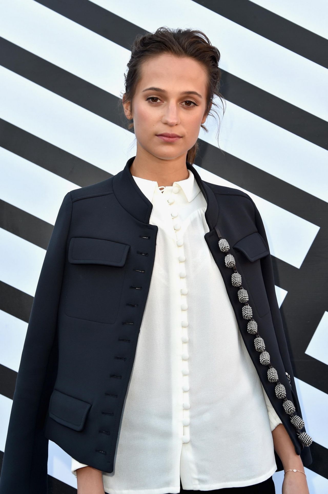 Alicia Vikander attends the star-studded Louis Vuitton show during