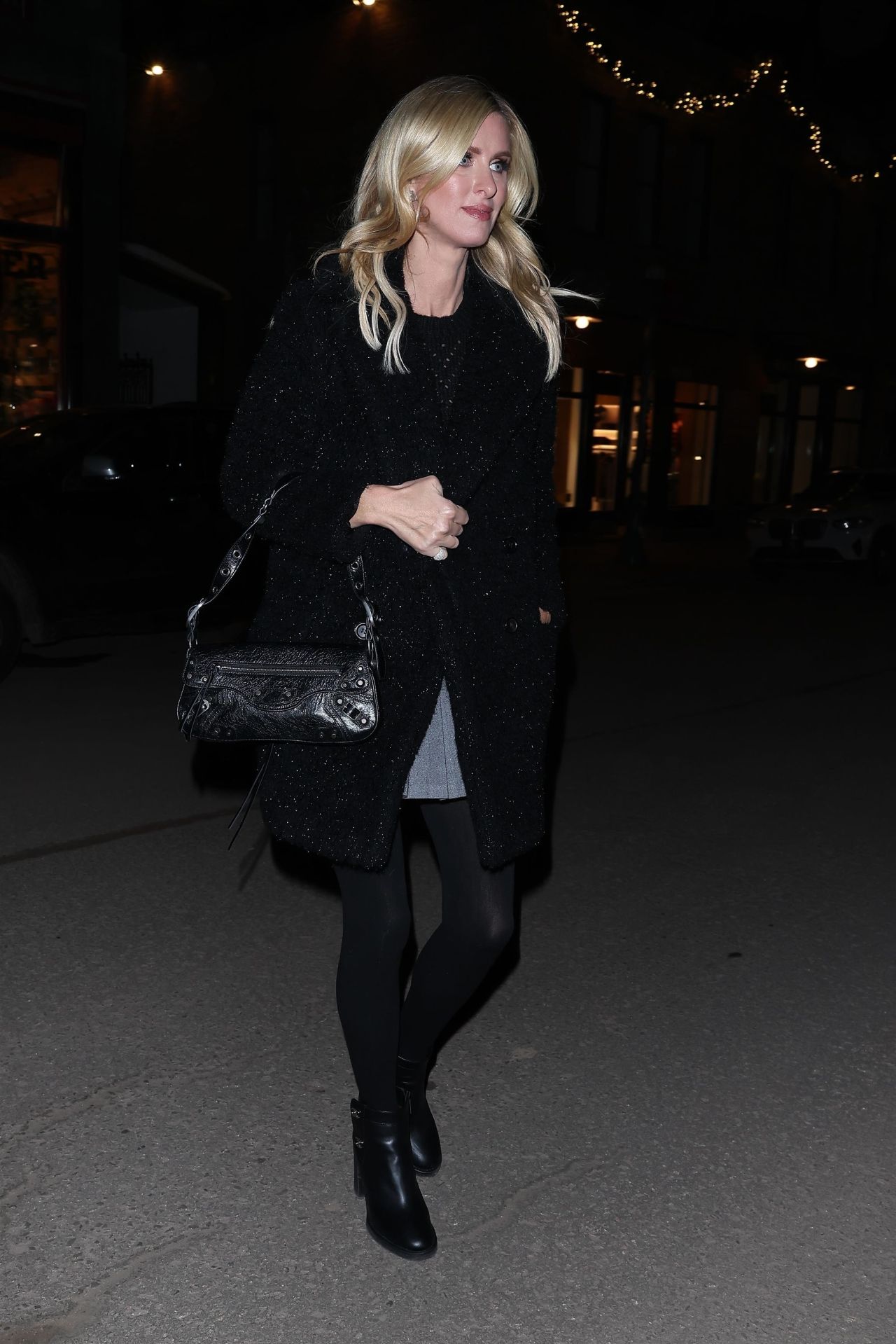 Nicky Hilton In A Sparkly Black Coat And Black Balenciaga Handbag