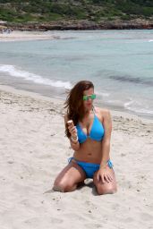 Imogen Thomas in a Blue Bikini - Eating a Ice Cream on a beach in Spain - June 2014