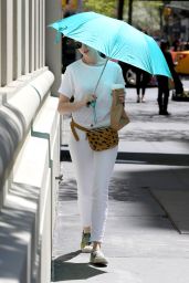 Anne Hathaway Spotted Using a Large Tturquoise Umbrella - New York City, April 2015