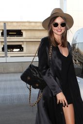Miranda Kerr in Black Mini Dress at LAX Airport in Los Angeles, September 2015