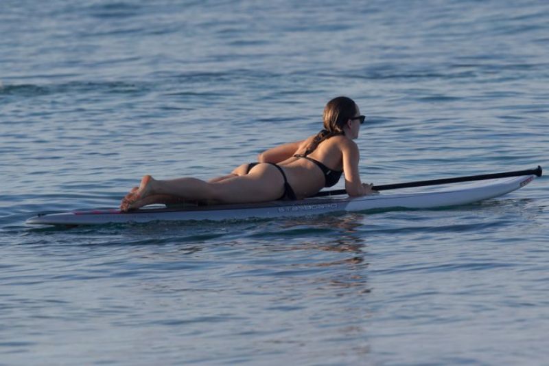 Olivia Wilde in a Bikini Paddle Board in Hawaii, December 2015.