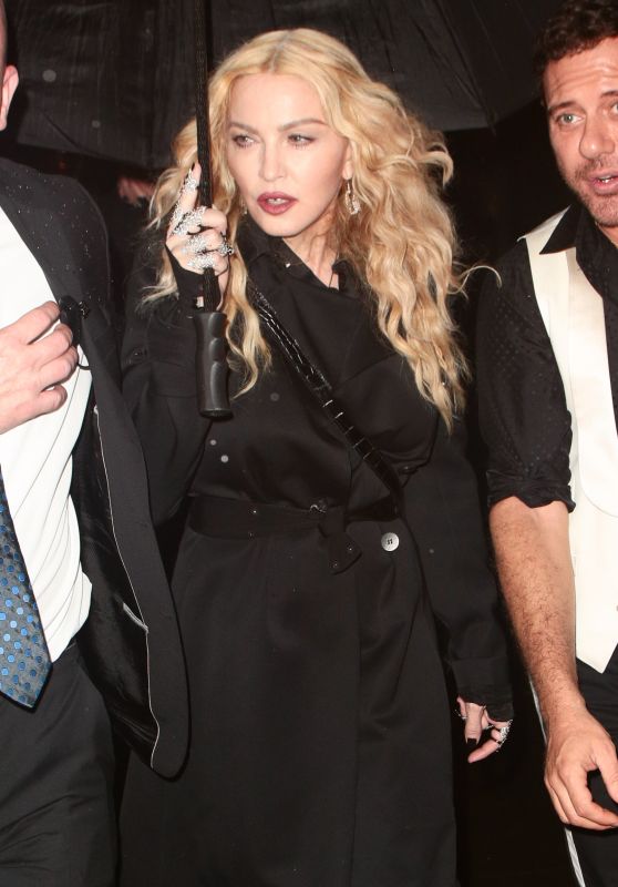 Madonna - Trying to Shield Herself From the Pouring Rain After Leaving the Met Gala in New York 5/2/2016