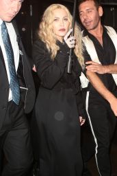 Madonna - Trying to Shield Herself From the Pouring Rain After Leaving the Met Gala in New York 5/2/2016