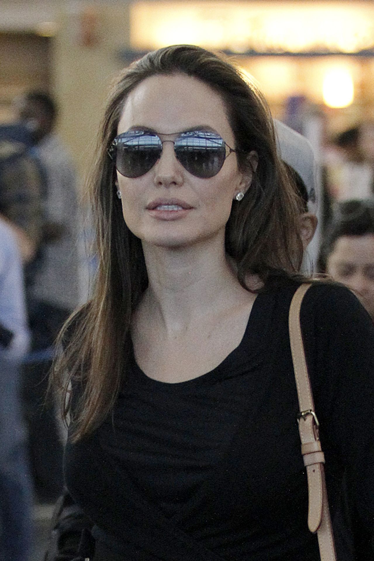 Angelina Jolie looks chic in a wool coat and sunglasses as she arrives at  JFK Airport in NYC