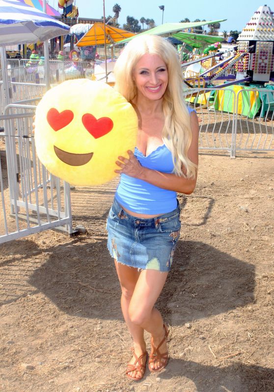 Sara Barrett Wins a Smiley Face Icon Pillow at the Fair in Malibu 9/4/2016