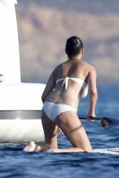 Chrissy Teigen in Bikini - Paddle Boarding in Sardinia 08/30/2017