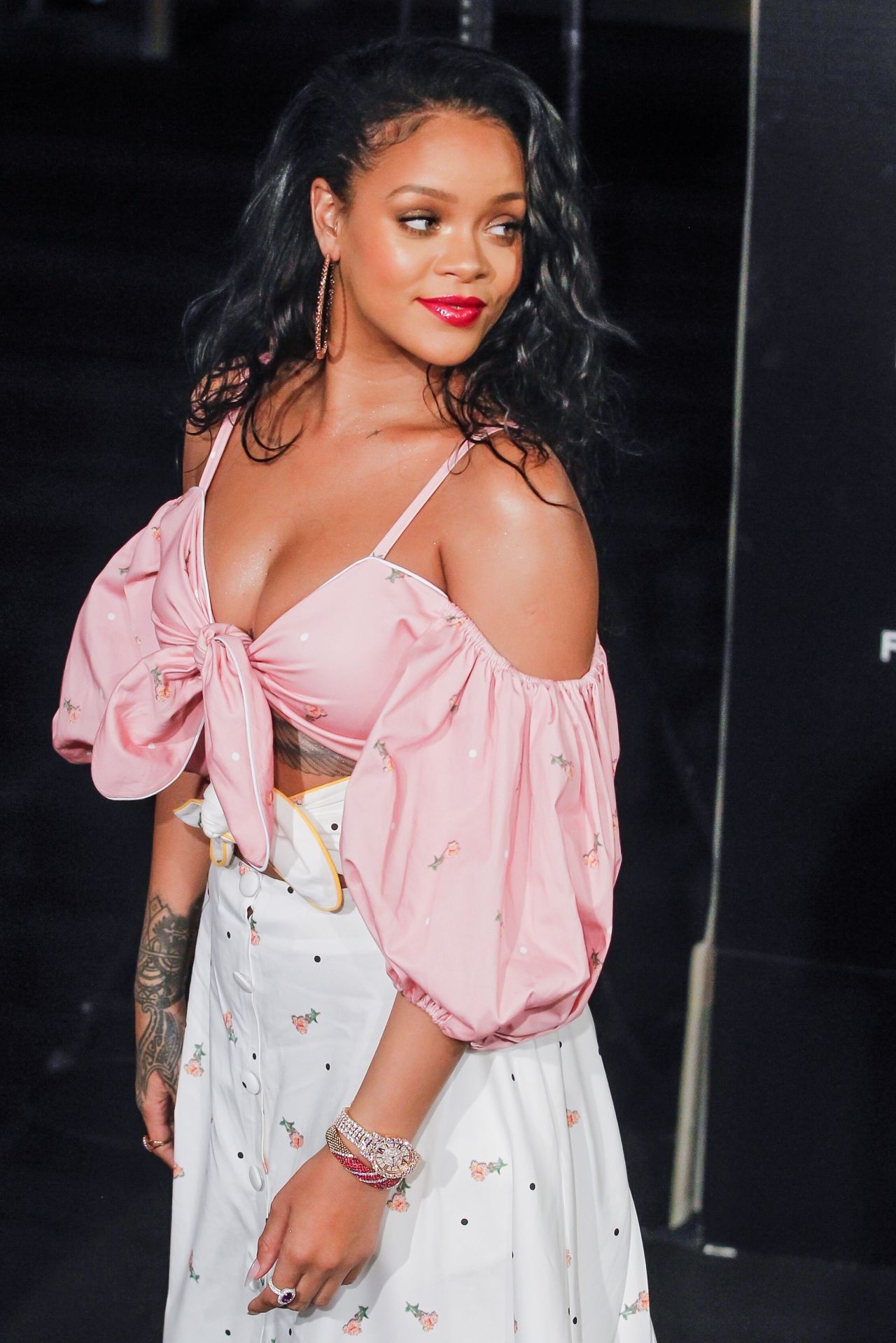 Rihanna wearing a very revealing yet classy pink top