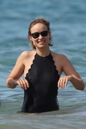 Olivia Wilde in a Black Swimsuit on the Beach in Hawaii 11/28/2017
