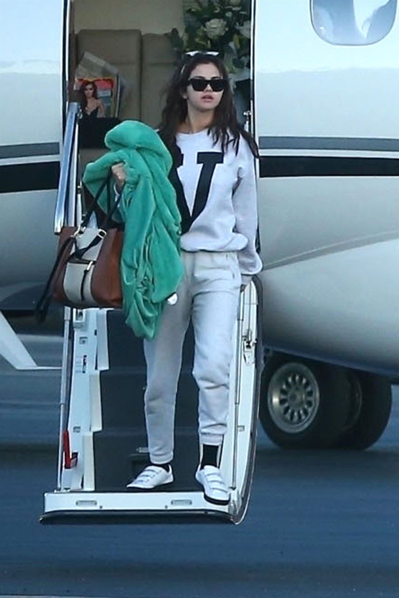 Selena Gomez Arriving on a Private Jet in Los Angeles • CelebMafia