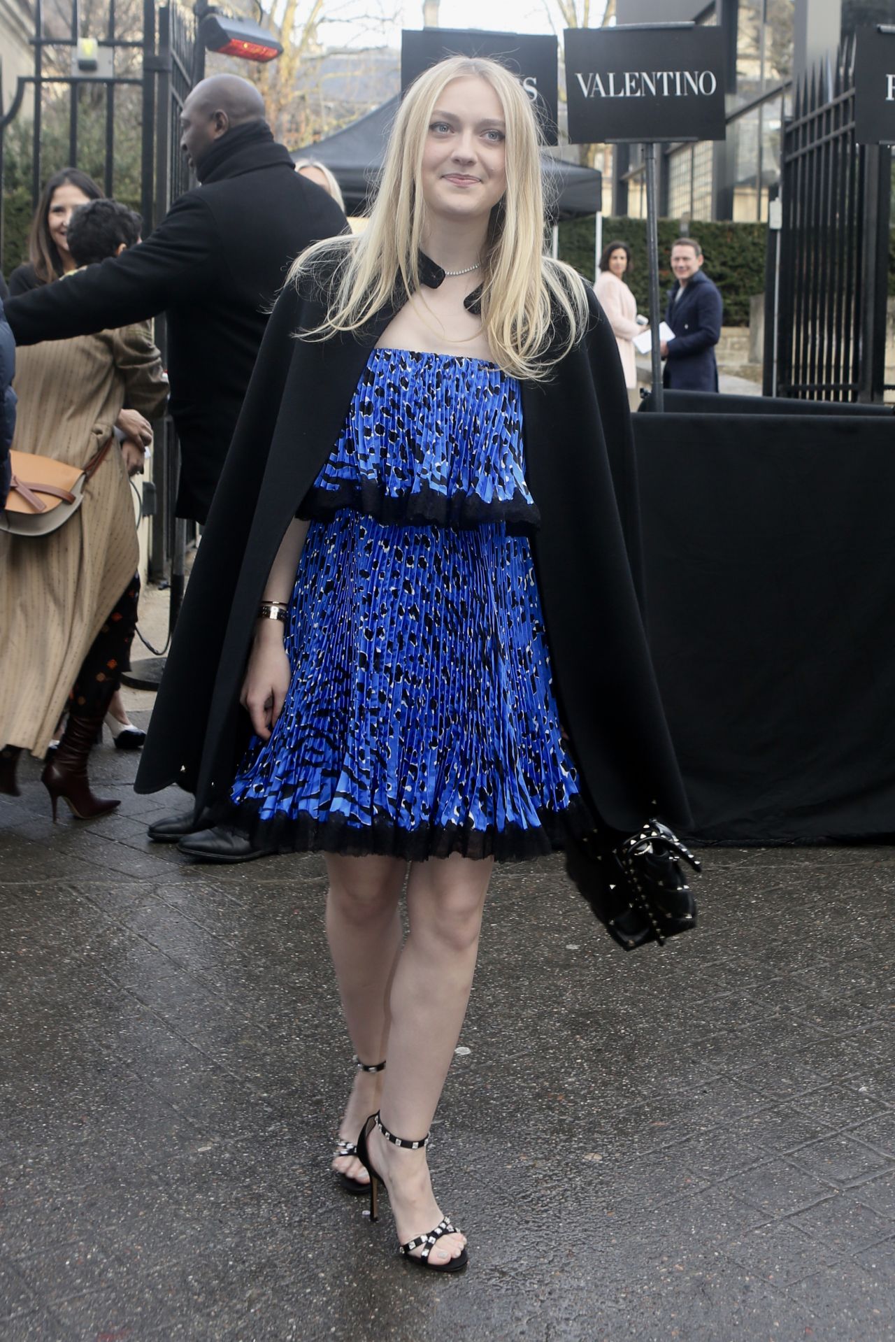 Valentino - Dakota Fanning captured before the Valentino Fall/Winter  2018-19 Show in Paris wearing a leopard statement dress from the Valentino  Fall 2018 Collection with the latest VLTN Valentino Garavani Candystud bag.