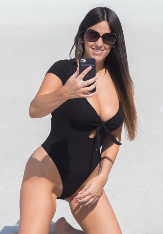 Claudia Romani in a Black Swimsuit on the Beach in Miami 05/28/2018