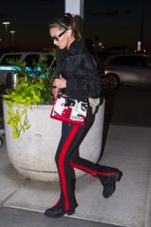 Bella Hadid in Fear Of God Pants with Off White Sunglasses and a Prada Handbag - JFK Airport in New York 06/14/2018