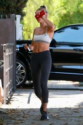 Hailey Baldwin in a White Sports Bra and Black Cropped Leggings in West Hollywood