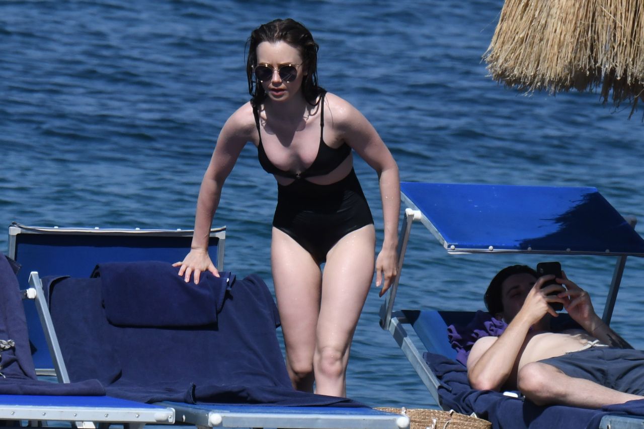 Lily Collins in a Black Swimsuit in Ischia Porto.
