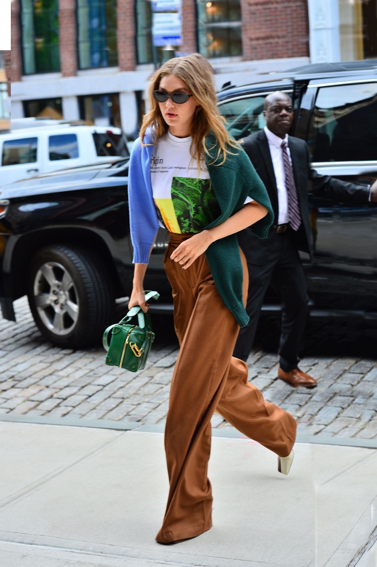 Gigi Hadid is Stylish in a White Graphic T-Shirt and Tan Colored High ...
