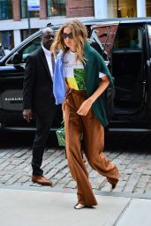 Gigi Hadid is Stylish in a White Graphic T-Shirt and Tan Colored High-Waisted Trousers 09/08/2019