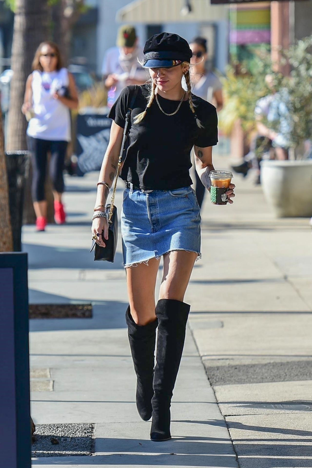 Miley Cyrus In Mini Denim Skirt And Knee High Black Boots 10172019