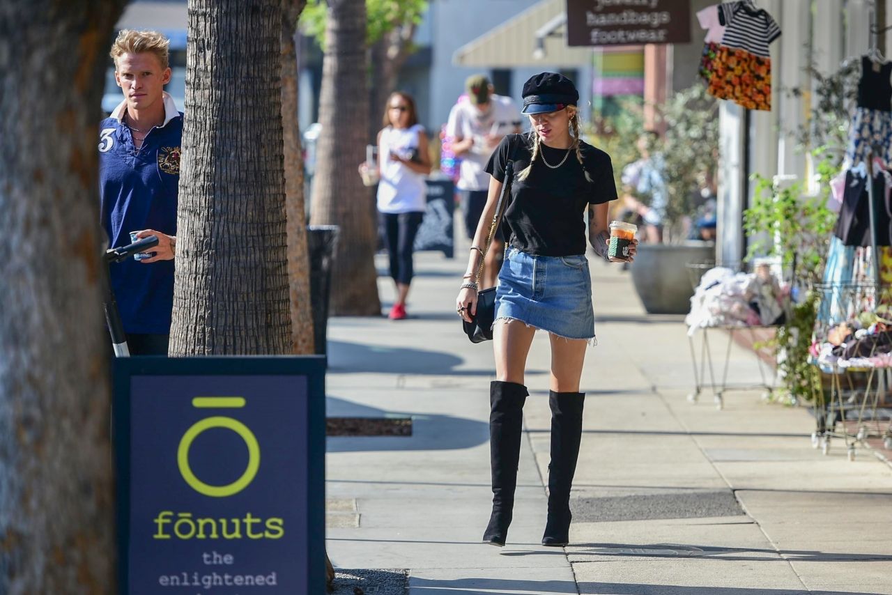 https://celebmafia.com/wp-content/uploads/2019/10/miley-cyrus-in-mini-denim-skirt-and-knee-high-black-boots-10-17-2019-5.jpg