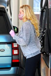 Holly Madison Wearing a Relaxed Grey Mickey Mouse Hoodie and Black Leggings