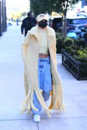 Hailey Bieber in a Thick, Fuzzy Yellow Coat and Pair of Baggy Acid Wash Jeans - NYC 10/17/2020