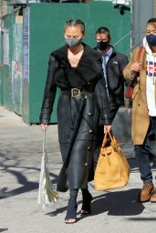 Chrissy Teigen in a Full-Length Black Leather Coat and Open-Toe High Heels - NY 03/07/2021