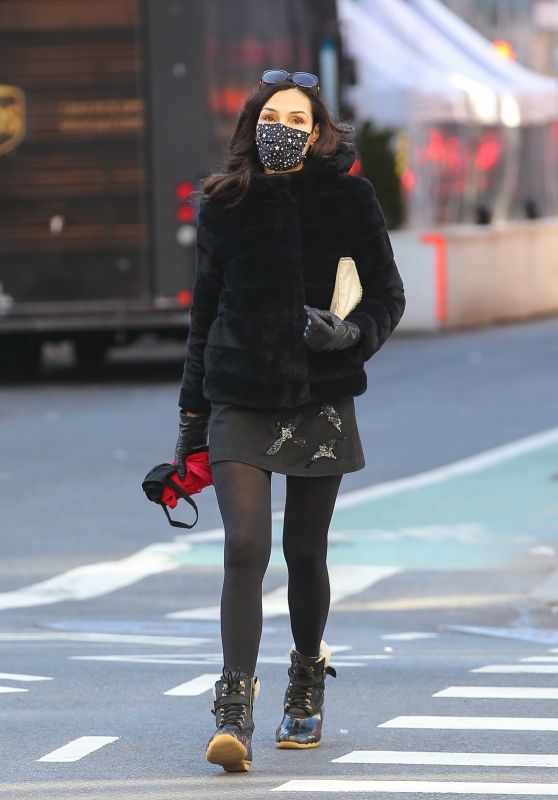 Famke Janssen Looks Stylish in a Black Faux Fur Puffer Jacket and a Mini-Skirt and Snow Boots 03/02/2021
