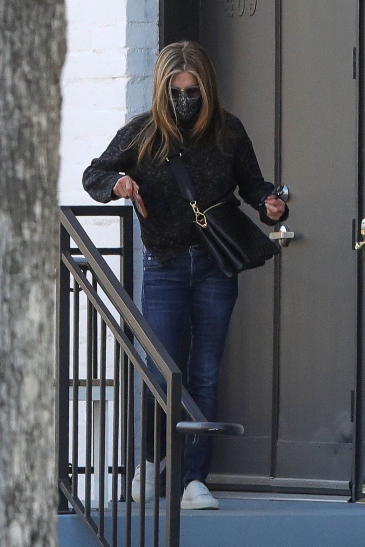 Jennifer Aniston Wears Black Sweater With Jeans at Hair Salon in LA