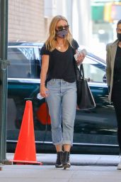 Kelly Ripa in Loose Fitting Faded Jeans and Carrying a Calvin Klein Wile E. Coyote Bag 04/07/2021
