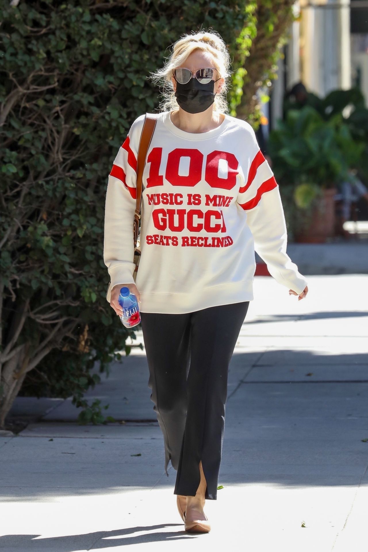 Rebel Wilson Wearing a Gucci 100 White Sweatshirt, Black Trousers and ...