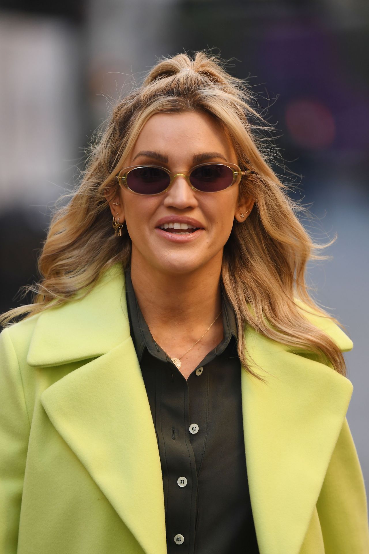 Ashley Roberts in a Lime Green Trench Coat and Striped Trousers