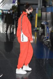 Selena Gomez in All Orange at JFK Airport in New York 11/22/2021