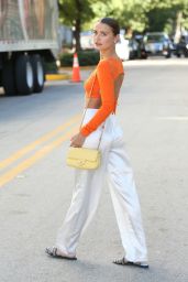 Yana Matkivski in an Orange Crop Top, White Satin Pants, Slides and Yellow Chanel Bag in Miami Beach 12/01/2021