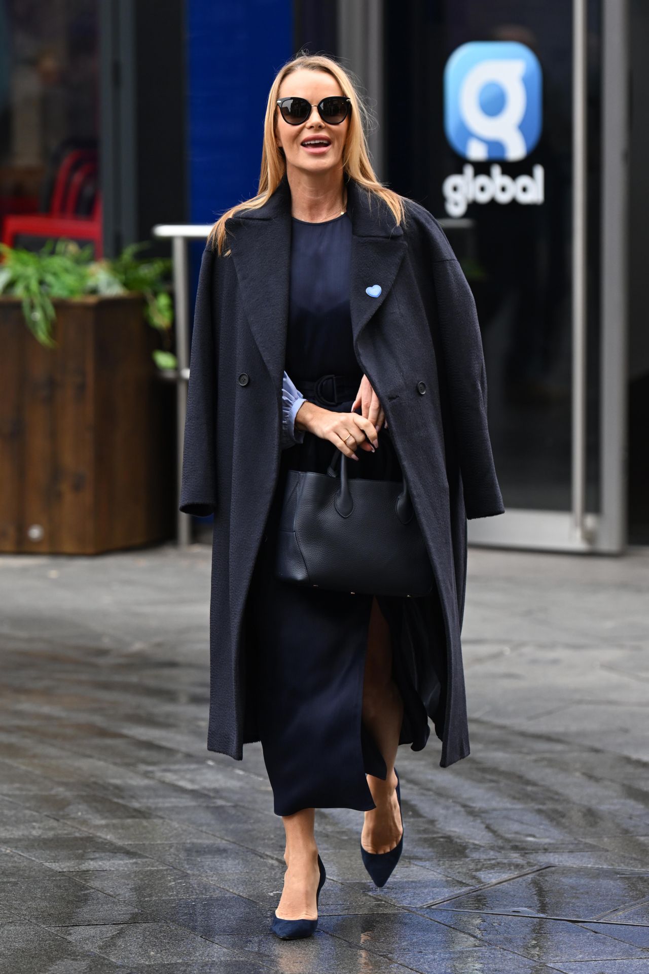 Amanda Holden goes braless as she makes an energetic exit from