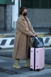 Anastasia Karanikolaou in an Oversized Coat and Snow Boots - Arrives in Milan 02/23/2022