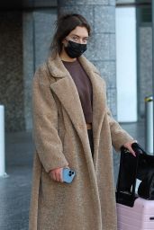 Anastasia Karanikolaou in an Oversized Coat and Snow Boots - Arrives in Milan 02/23/2022
