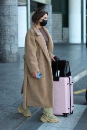 Anastasia Karanikolaou in an Oversized Coat and Snow Boots - Arrives in Milan 02/23/2022