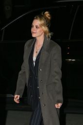 Kristen Stewart Wears a Black Pinstripe Suit and Overcoat - New York 03/10/2022
