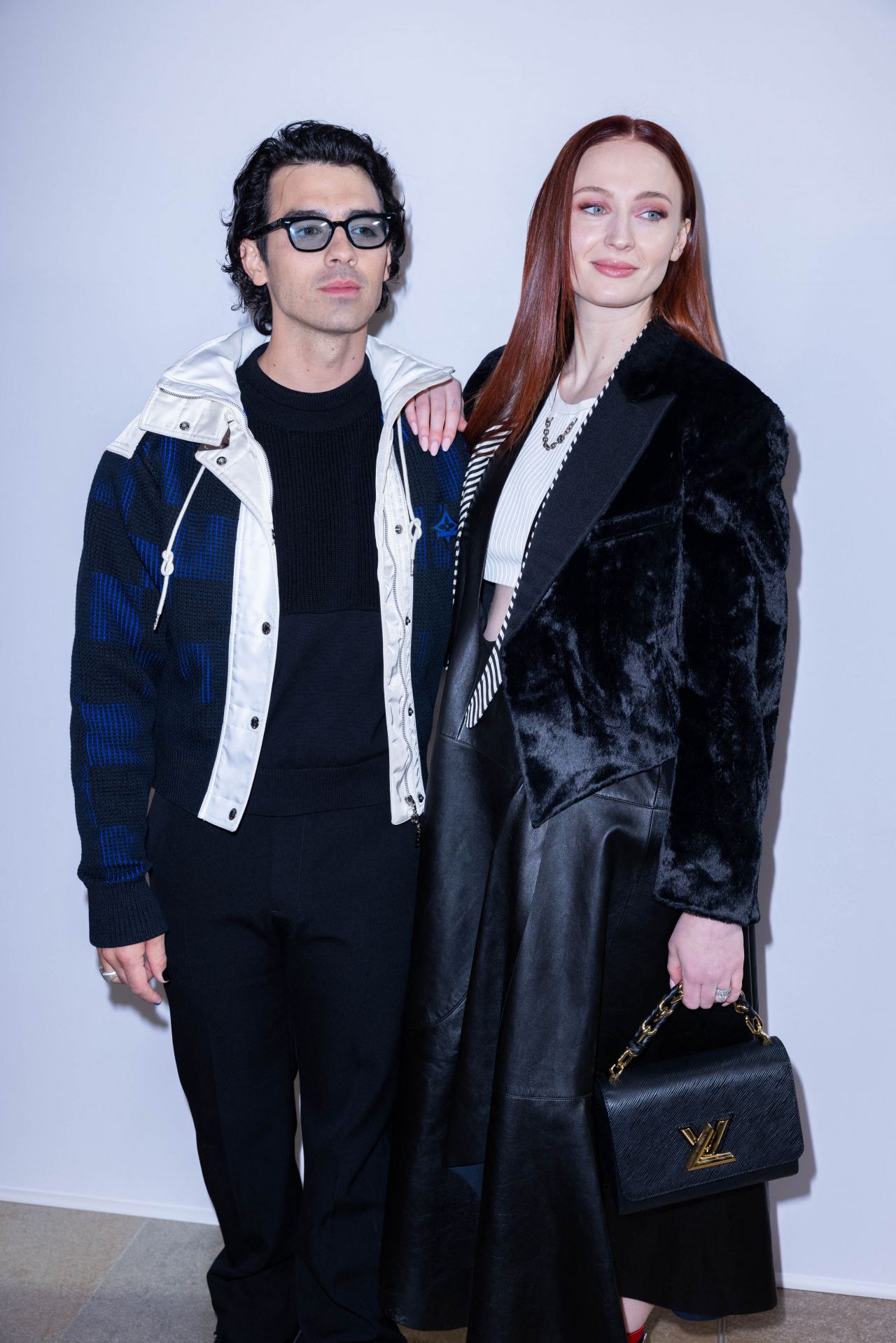 Sophie Turner lets her Louis Vuitton Petite Boite Chapeau Bag meet its  other LV bag cousins at the Louis Vuitton show…