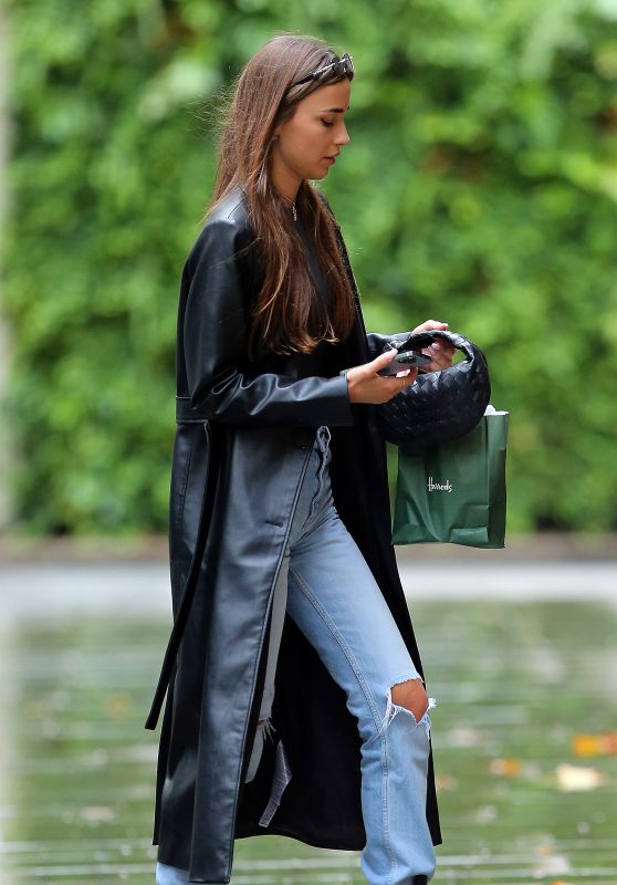 Maria Beregova in a Long Leather Mac Coat, Black Top, Ripped Jeans and a Pair of Prada Boots 09/08/2022