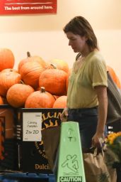 Milla Jovovich in Jeans and a Yellow V-neck T-shirt at Whole Foods in Beverly Hills 09/20/2022