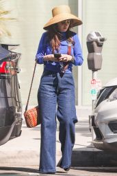 Zoey Deschanel Wears Bell Bottom Jeans and a Straw Hat at the Proper Hotel in Santa Monica 10/22/2022