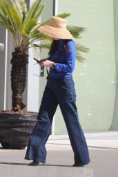 Zoey Deschanel Wears Bell Bottom Jeans and a Straw Hat at the Proper Hotel in Santa Monica 10/22/2022