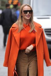 Amanda Holden in Beige Flared Trousers and Orange Coat in London 11/11/2022