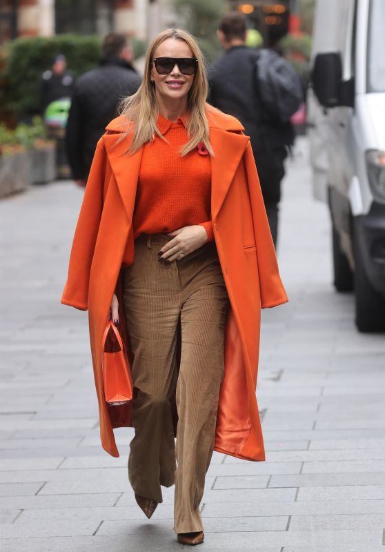 Amanda Holden in Beige Flared Trousers and Orange Coat in London 11/11/2022
