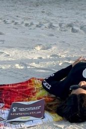 Claudia Romani on the Beach Wearing a World Cup Long Sleeve Shirt and Black Bikini Bottoms in Miami 11/27/2022