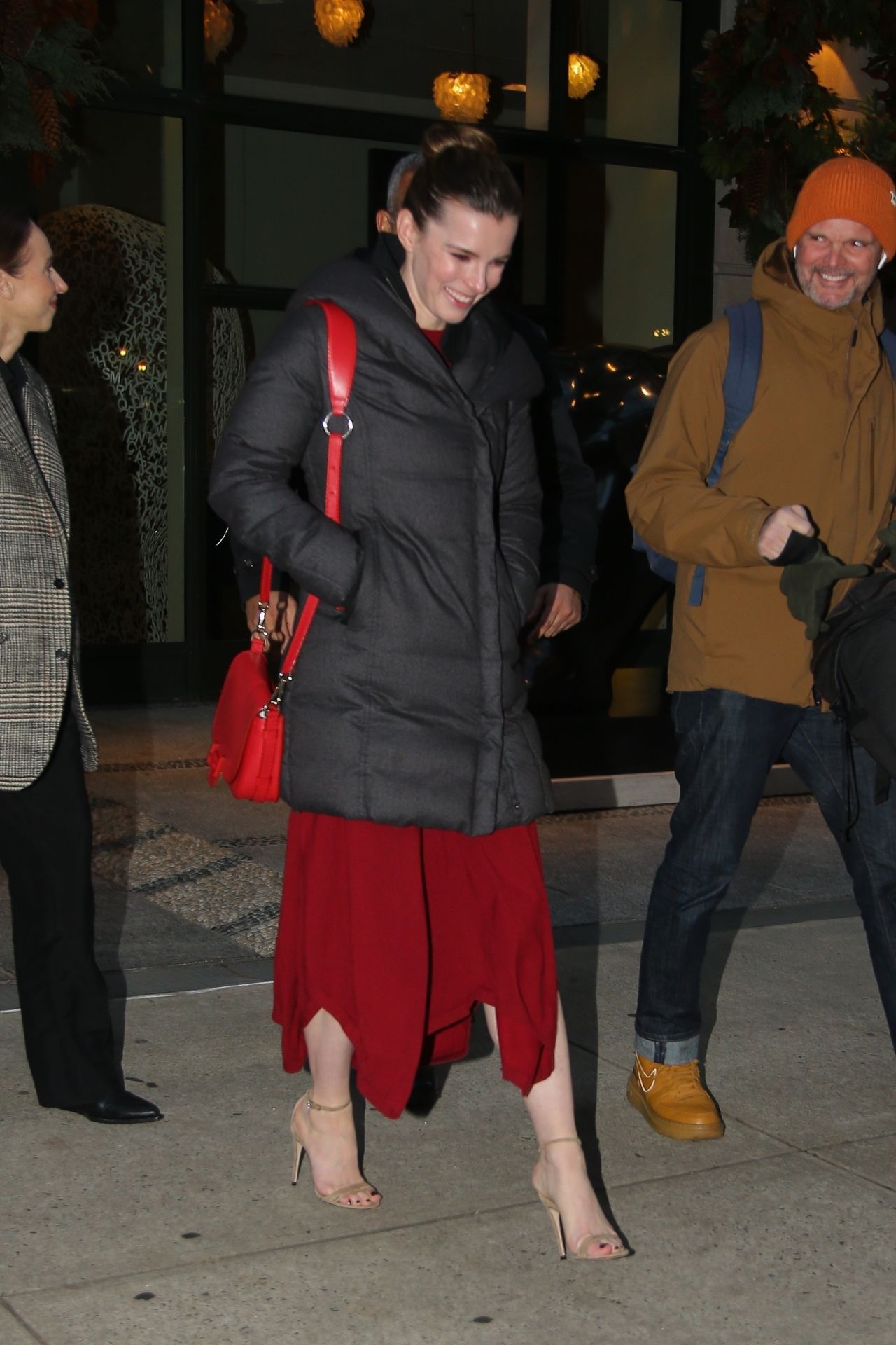 Elizabeth Gilpin in a Red Dress and Black Puffer Jacket - New York 12