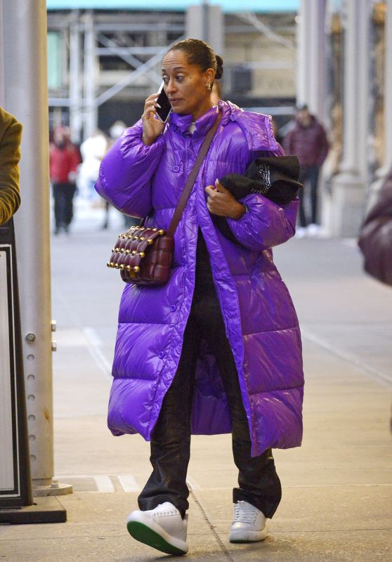 Tracee Ellis Ross Wearing a Long Purple Bubble Coat, Black Pants, White Sneakers and Brown Leather Shoulder Bag 12/21/2022