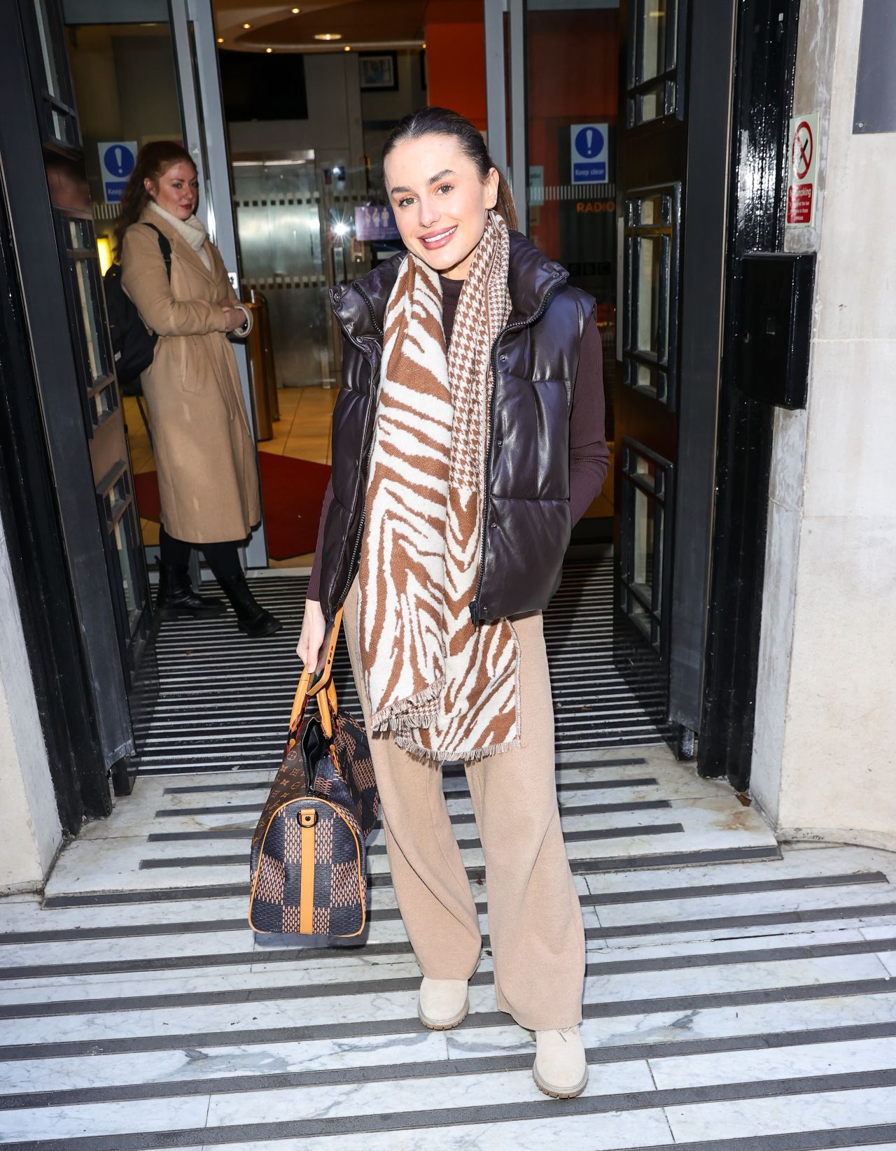 Amber Davies Wearing a Winter Scarf and Body Warmer - London 01/16/2023