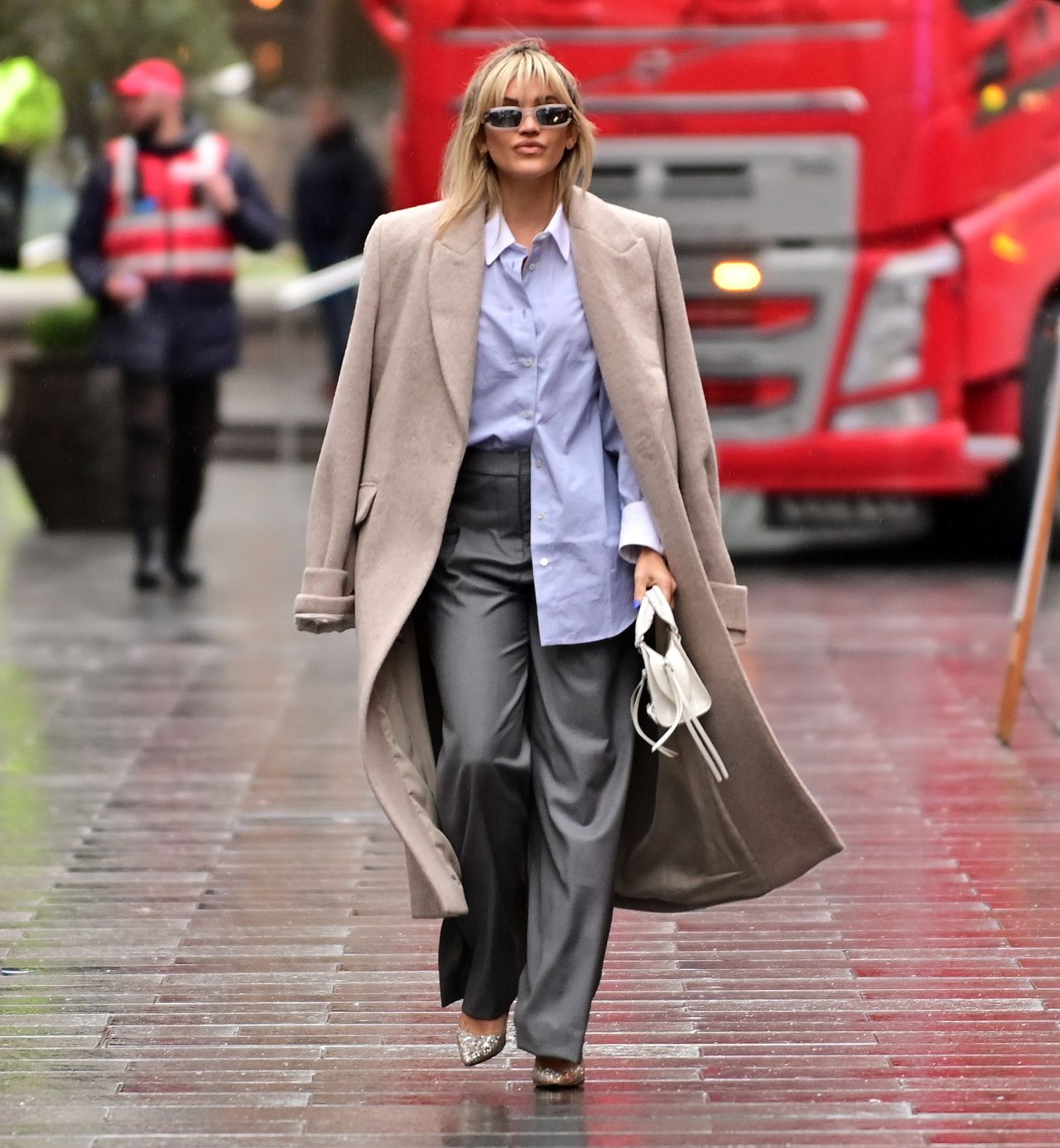 Ashley Roberts in Grey Deep Pleated Trousers and a Blue Shirt in London